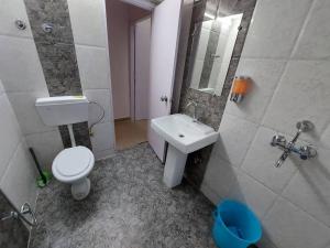 a bathroom with a toilet and a sink at Skyline 2BHK Independent flat in Lucknow