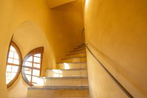 a staircase in a house with a round window at Torre Veglio in Terruggia