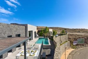 a villa with a swimming pool and a house at Las Yucas 12 by VillaGranCanaria in Salobre