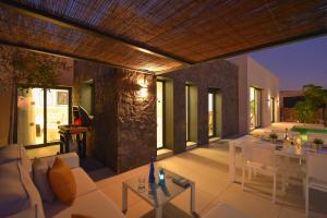 a living room with a couch and a table at Las Yucas 12 by VillaGranCanaria in Salobre