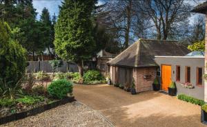 a house with a driveway leading to a garage at Byford Lodge Luxury self-catering in Louth in Louth