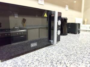 a microwave sitting on a counter in a kitchen at Luxury waterview 2BD in Sharjah