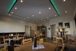 a restaurant with wooden tables and chairs and lights at Ferienwohnung Jo Secco in Bruttig-Fankel