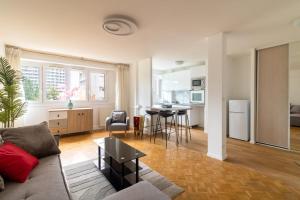 a living room with a couch and a table in it at Comfortable apartment with view - Welkeys in Puteaux