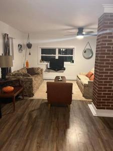 a living room with a couch and a tv at Sunset View in OʼLeary