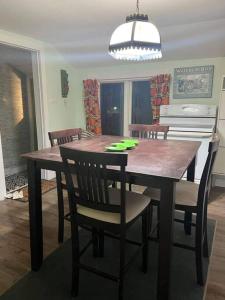 a wooden table and chairs in a kitchen with a dining room at Sunset View in OʼLeary