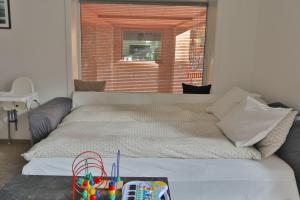 a bed in a room with a large window at Bjørvika - Beside the sea & in the city, near Oslo Centralstation in Oslo