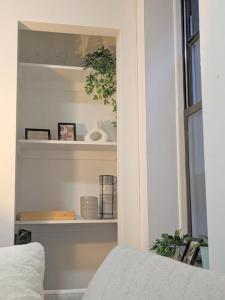 a room with a shelf with items on it at Modern One Bedroom in Union Sq - great location in New York