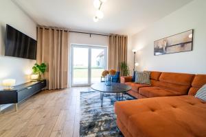 a living room with a couch and a table at Dom Przystanek Tałty in Mikołajki