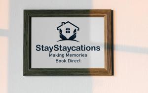 a picture of a sign in a frame on a wall at The Den by StayStaycations in Rugeley