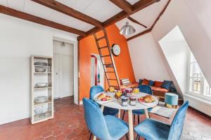 a room with a table and chairs and a ladder at Latin Quarter with Mezzanine - CityApartmentStay in Paris