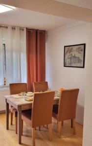 jadalnia z drewnianym stołem i krzesłami w obiekcie Gästehaus Da Fabio w mieście Bad Bocklet