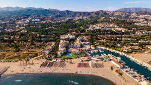 an aerial view of a beach with a resort at Mimosas Penthouse Marbella Cabopino in Marbella