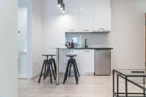 a kitchen with a counter and stools in a room at Syntagma square, 60sqm Platinum suite in Athens +24 photos