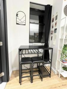 a black desk with two black chairs and a mirror at Studio in Union Square in New York