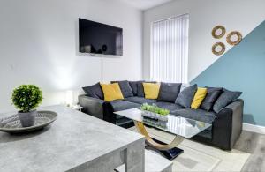 a living room with a couch and a table at Merrivale House in Birmingham