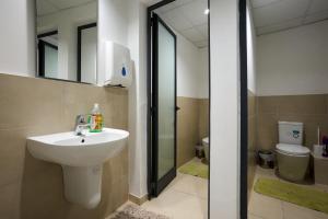 a bathroom with a sink and a toilet at Holiday Home in Marsaskala in Marsaskala