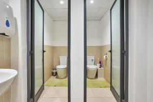 a bathroom with two toilets and a sink at Holiday Home in Marsaskala in Marsaskala