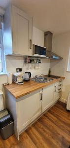 a kitchen with a sink and a counter top at Self-contained Guest Suite in Guildford