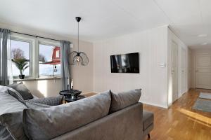a living room with a couch and a tv at Guestly Homes - Homely 2BR Apartment with 3 Beds in Boden