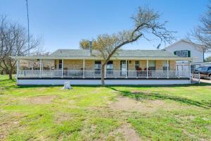 a large yellow house with a white porch at Expansive Bertram Retreat with Pool, on 28 Acres! in Bertram