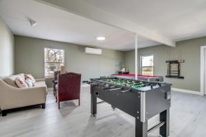 a living room with a foosball table in the middle at Expansive Bertram Retreat with Pool, on 28 Acres! in Bertram