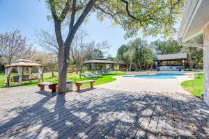 a park with two benches and a playground at Expansive Bertram Retreat with Pool, on 28 Acres! in Bertram