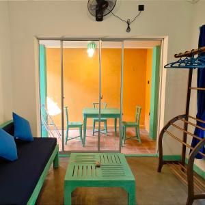 a living room with a green table and chairs at Mahi-Mahi Villa in Dickwella