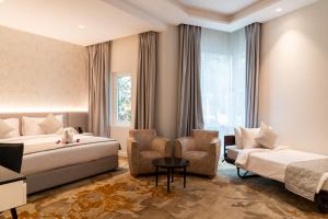 Postel nebo postele na pokoji v ubytování eStay Hotel