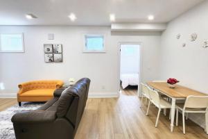 a living room with a couch and a table at Serene High-celling Retreat in Oakville