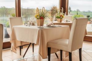 a table with a white tablecloth and chairs and a window at Tenuta Tralice in Ruviano