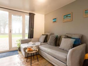 a living room with a couch and a table at Chalet Bushwood Lodge by Interhome in Helston