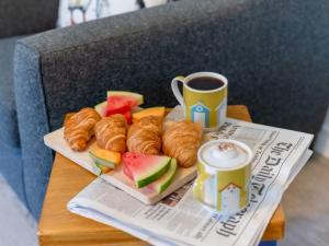a tray of pastries and a cup of coffee on a table at Holiday Home Marshmallow House by Interhome in St Austell