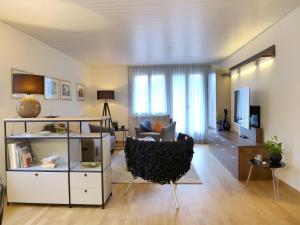 a living room with a couch and a chair at Apartment Beatrice Garden by Interhome in Leissigen