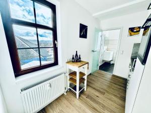 a room with a window and a table with wine bottles on it at FeWo Münch im Netz BITTE suchen ZZ-Braunlage in Braunlage
