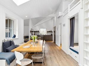 a dining room and living room with a table and chairs at Holiday Home Loviisa - 850m from the sea by Interhome in Gilleleje