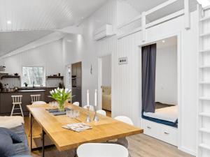 a dining room with a table and a bunk bed at Holiday Home Loviisa - 850m from the sea by Interhome in Gilleleje