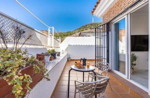 patio con mesa y sillas en el balcón en Casa con piscina y chimenea en Albayzin alto en Granada