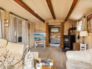 a living room with a couch and a fireplace at Holiday Home Arlina - 750m from the sea in Sealand by Interhome in Fårevejle