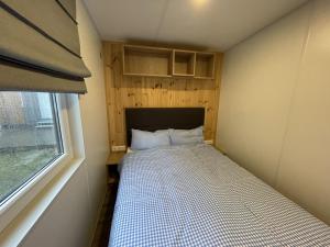 a small bed in a small room with a window at Holiday Home Christian by Interhome in Wemding