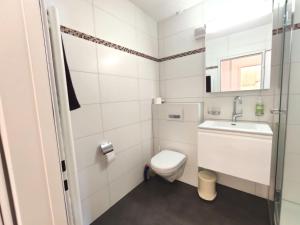 a small bathroom with a toilet and a sink at Studio Haus Arabelle by Interhome in Davos