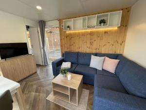 a living room with a blue couch and a table at Holiday Home Tiny Haus Family-Home by Interhome in Riedenburg