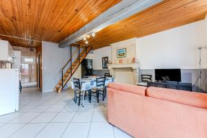 a living room with a couch and a table at Chez Lea in Saint-Seurin-de-Cadourne