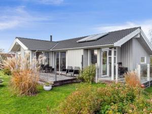 a home with a deck and a house at Holiday Home Elja - 400m to the inlet in Sealand by Interhome in Jægerspris