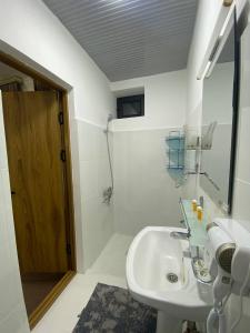 a bathroom with a sink and a mirror at HOTEL KARVON SHAHRISABZ in Shahrisabz