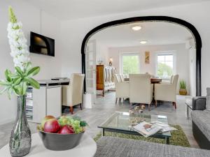 a living room with a table with a bowl of fruit at Holiday Home Aliza - 14km from the sea in Western Jutland by Interhome in Bredebro