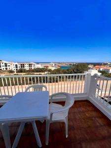 a white table and two chairs on a balcony at Apartamento 204 Castell Sol CB in Arenal d'en Castell