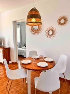 a dining room with a table and white chairs at Apartamento 204 Castell Sol CB in Arenal d'en Castell