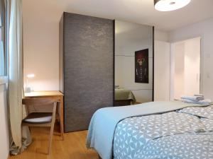 a bedroom with a bed and a desk and a chair at Apartment Ibex by Interhome in Kandersteg