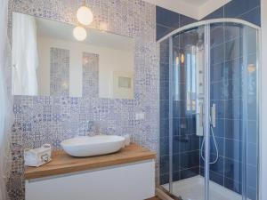 een badkamer met een wastafel en een glazen douche bij Apartment La casa dei limoni di Valeria by Interhome in Torre del Lago Puccini